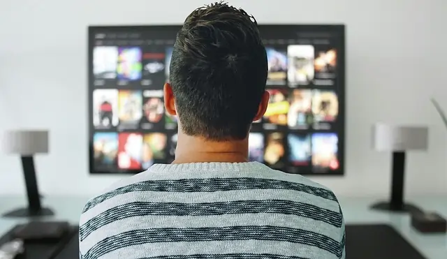 gym member sitting at home and watching tv